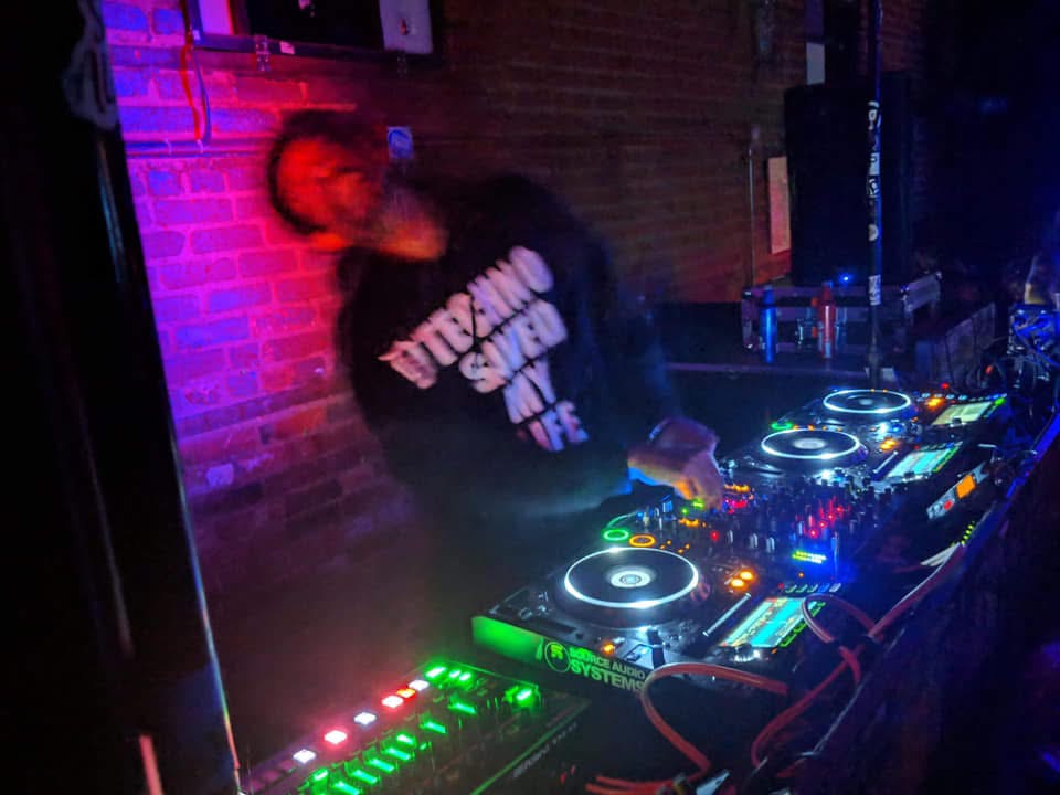 Augustus Williams DJing with projected visuals