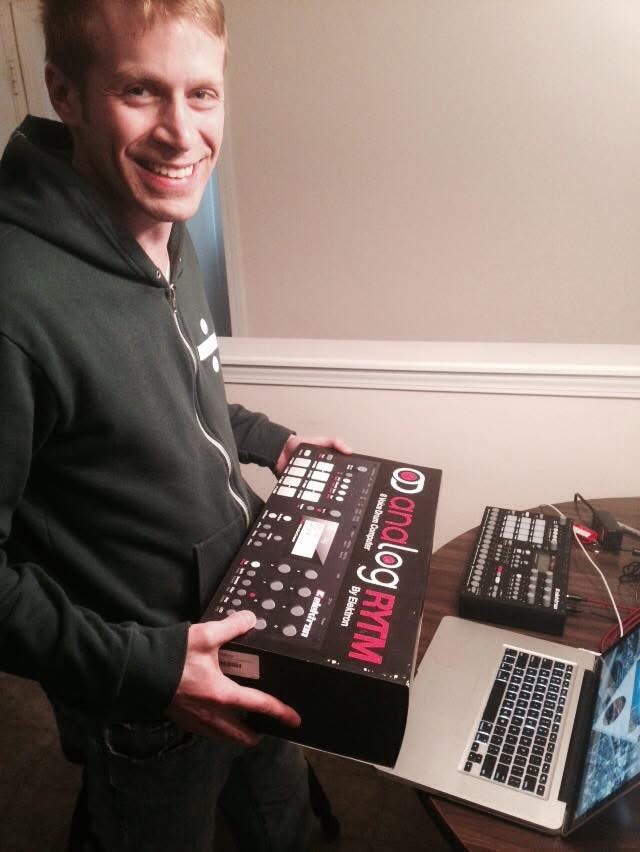 Artist holding a Dmology RXM drum machine
